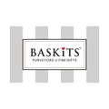 A centered rectangular logo card reading 'BASKiTS PURVEYORS OF FINE GIFTS' with a small red heart above the S, set against a white background with light gray vertical stripe shapes behind it.
